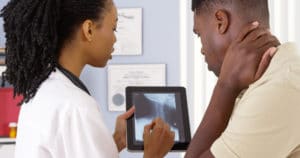 doctor looking over x-ray with patient