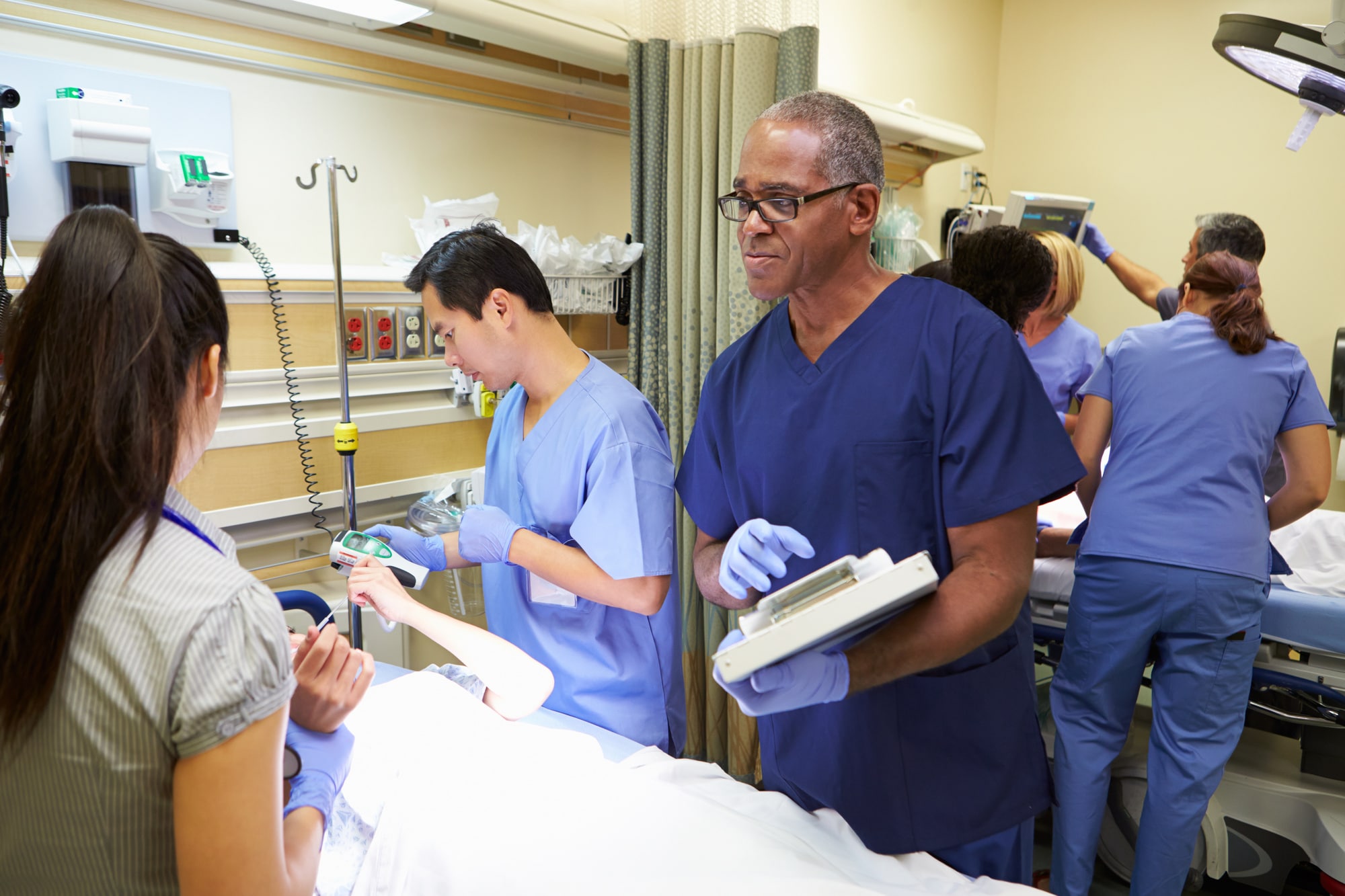 doctors checking patient's vitals in urgent care room