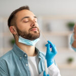 Man getting a nose swab from a doctor